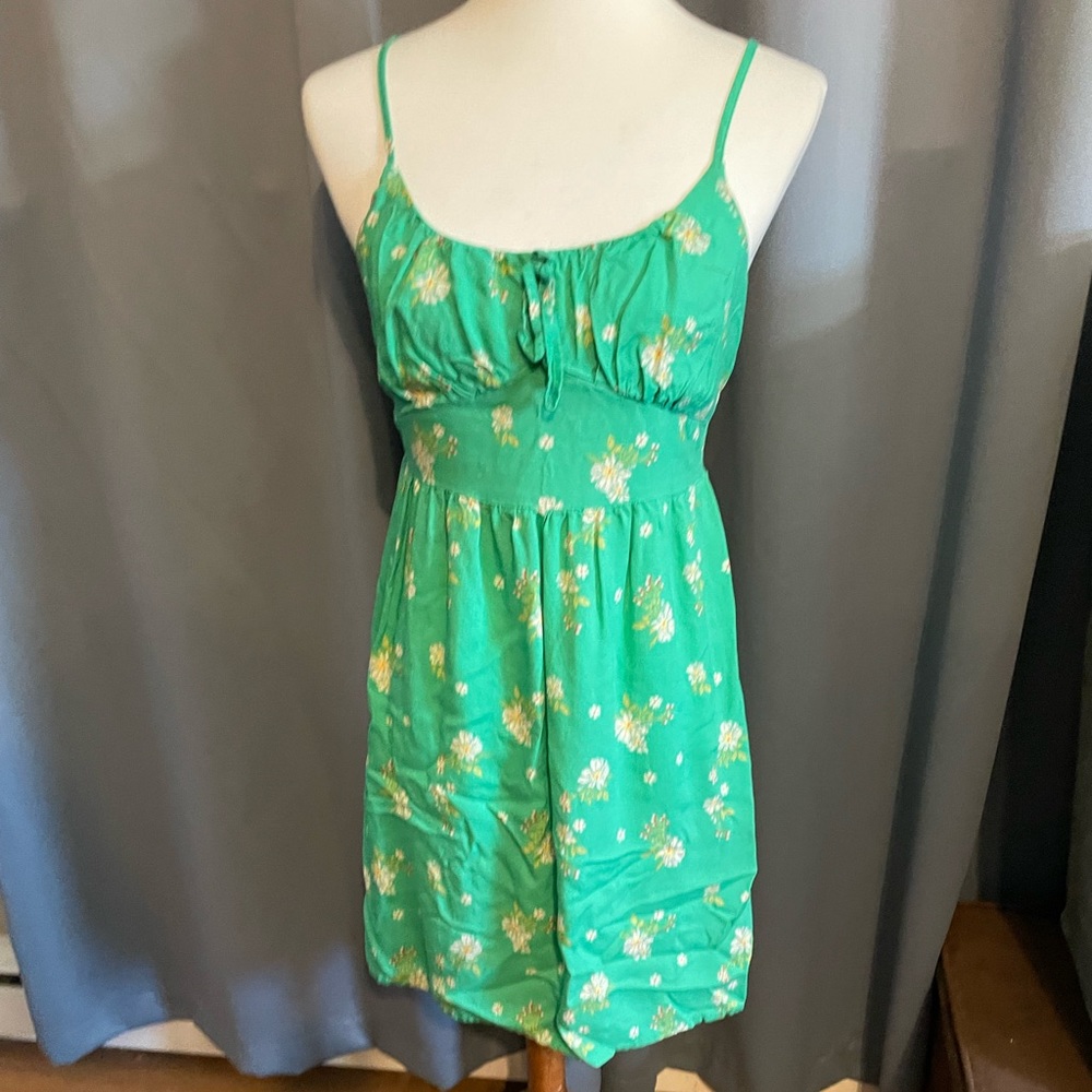 Green floral sundress with adjustable spaghetti straps.